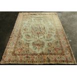 A large country house Isfahan carpet with an all over floral design on a pale green ground and