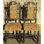 A pair of Victorian carved oak high back dining/side chairs with trailing vine and turned supports
