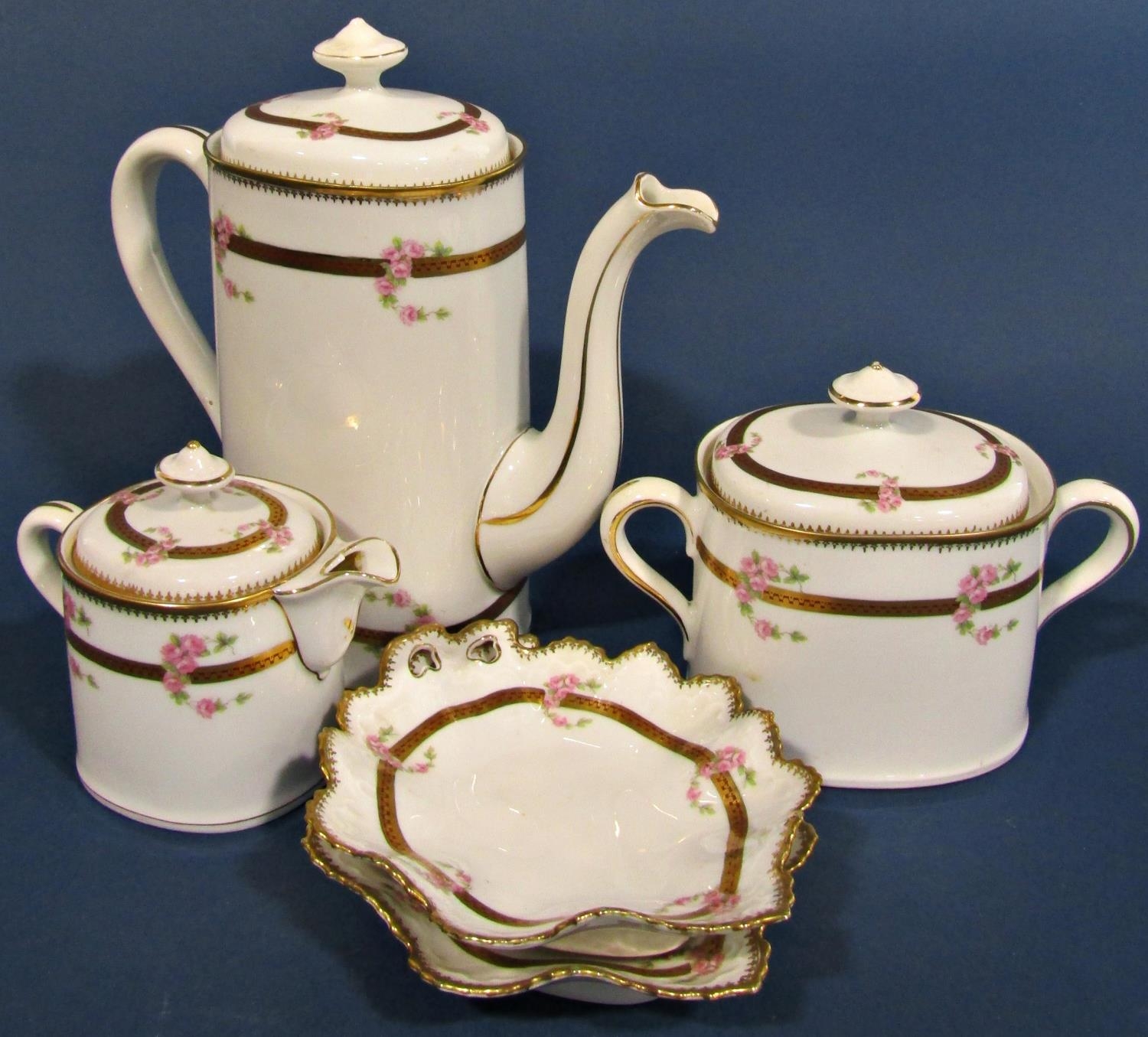 A continental porcelain coffee set with trailing pink floral swags within gilt borders
