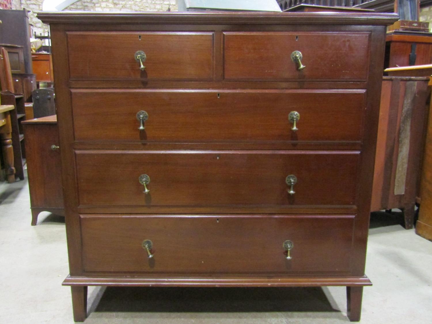 An Edwardian mahogany dressing chest of three long and two short graduated drawers flanked by