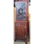 A small 19th century mahogany two sectional side cabinet, the lower enclosed by a fielded panelled