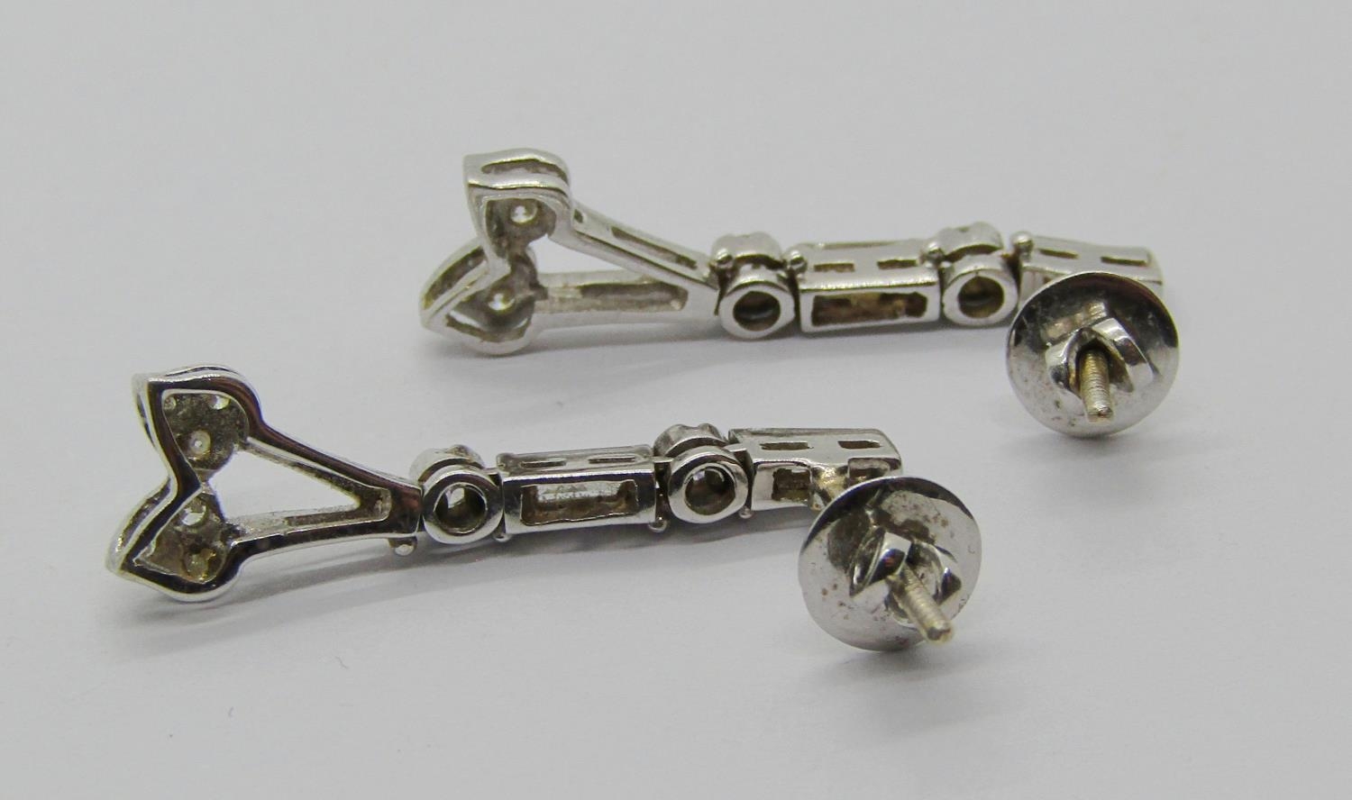 Pair of stylised 18ct white gold articulated drop earrings set with baguette and round-cut diamonds, - Image 2 of 2