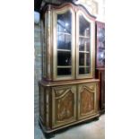 A floorstanding two sectional continental side cabinet with decorative painted finish enclosed by