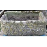 A weathered rectangular natural stone trough with rounded front corners, single notch/channel 102 cm