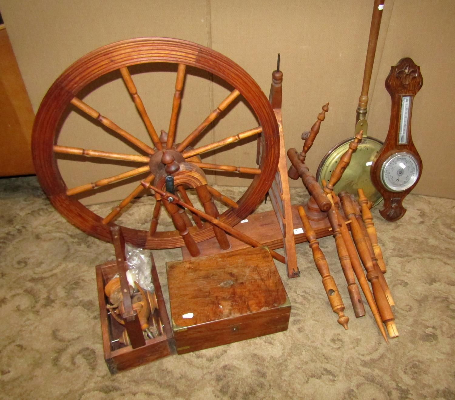 A traditional pine and beechwood spinning wheel together with a 19th century walnut writing slope,