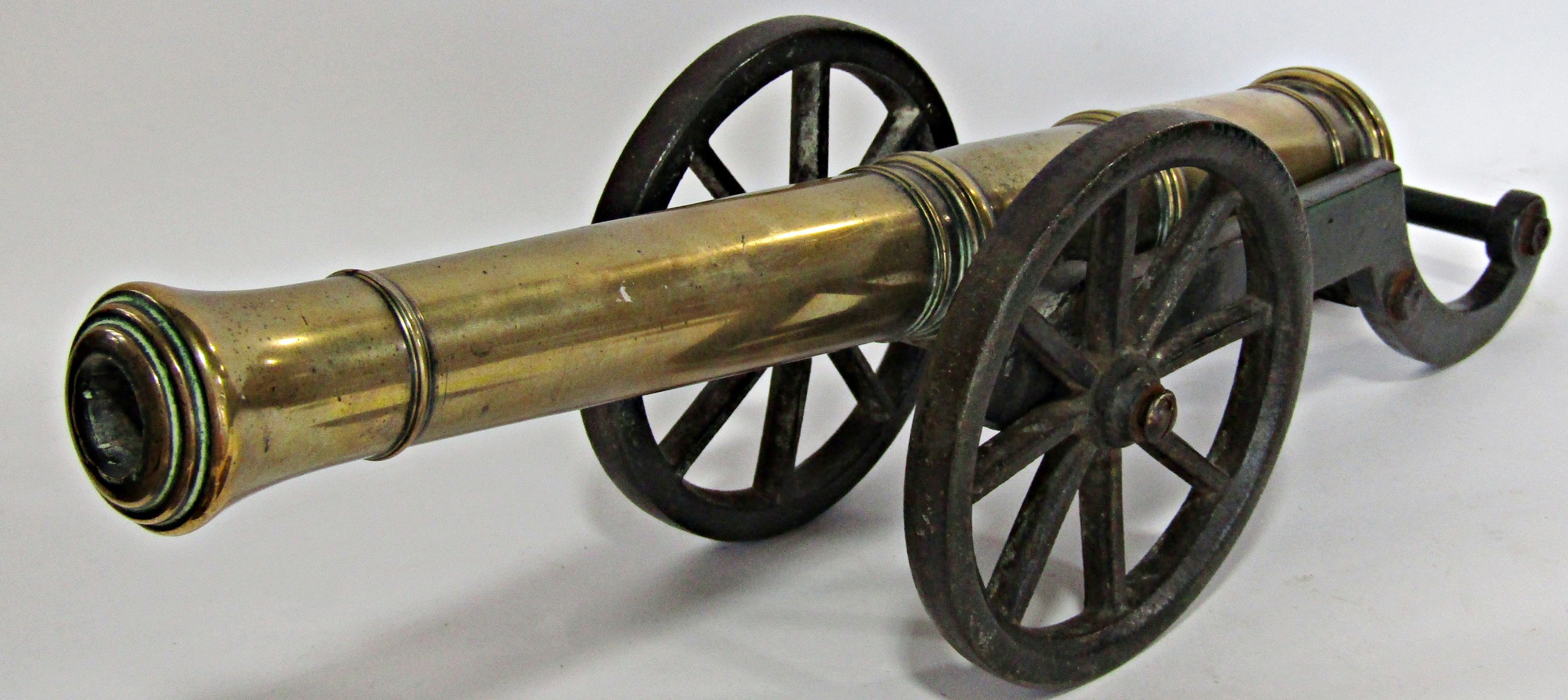 A 19th century bronze and cast iron model of a field canon, the bronze barrel 38cm long raised on