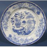 A 19th century Chinese blue and white plate, with peony, bamboo and other repeating floral detail,