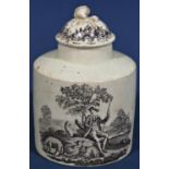 An 18th century cylindrical cream ware tea caddy and cover with pastoral landscapes