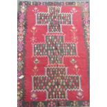 A South West Persian Qashgai Kelim, with a repeating all over pattern on a dark red field, 385cm x