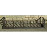 A blacksmith made iron fender with simple scroll detail, the curb 136 cm wide x 32 deep, internal