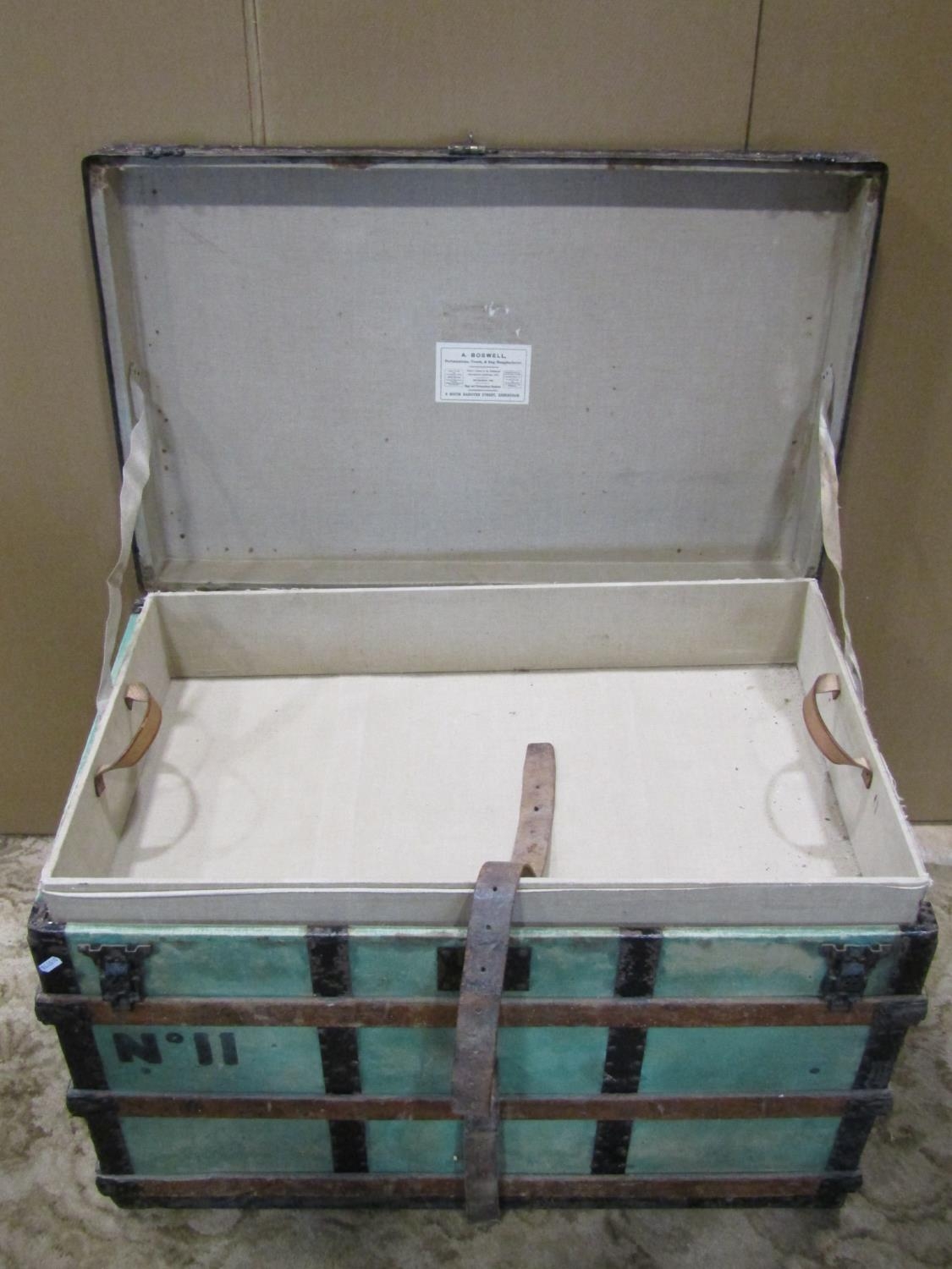 A wooden lathe and steel banded trunk with hinged lid and stitched leather carrying handles, label - Image 3 of 4