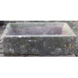 A weathered rectangular natural stone trough with canted interior 102 cm long x 62 cm wide x 30 cm