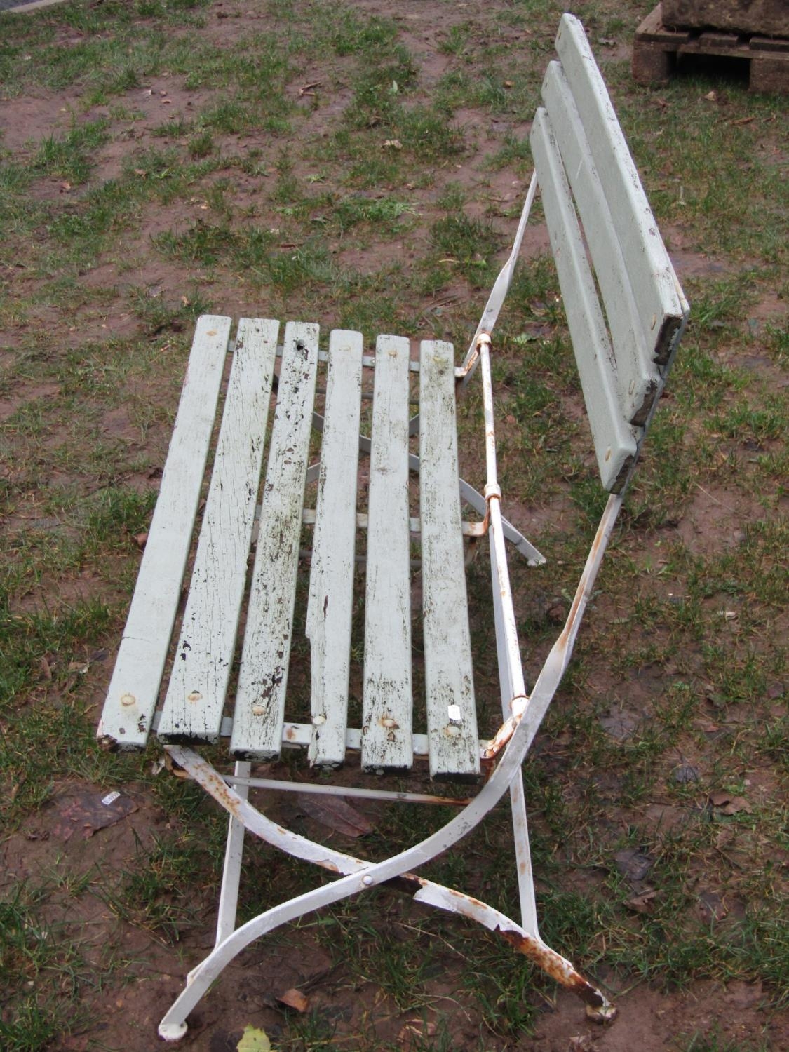 A painted and weathered iron framed folding two seat garden bench with painted wooden slats, (af), - Image 2 of 2