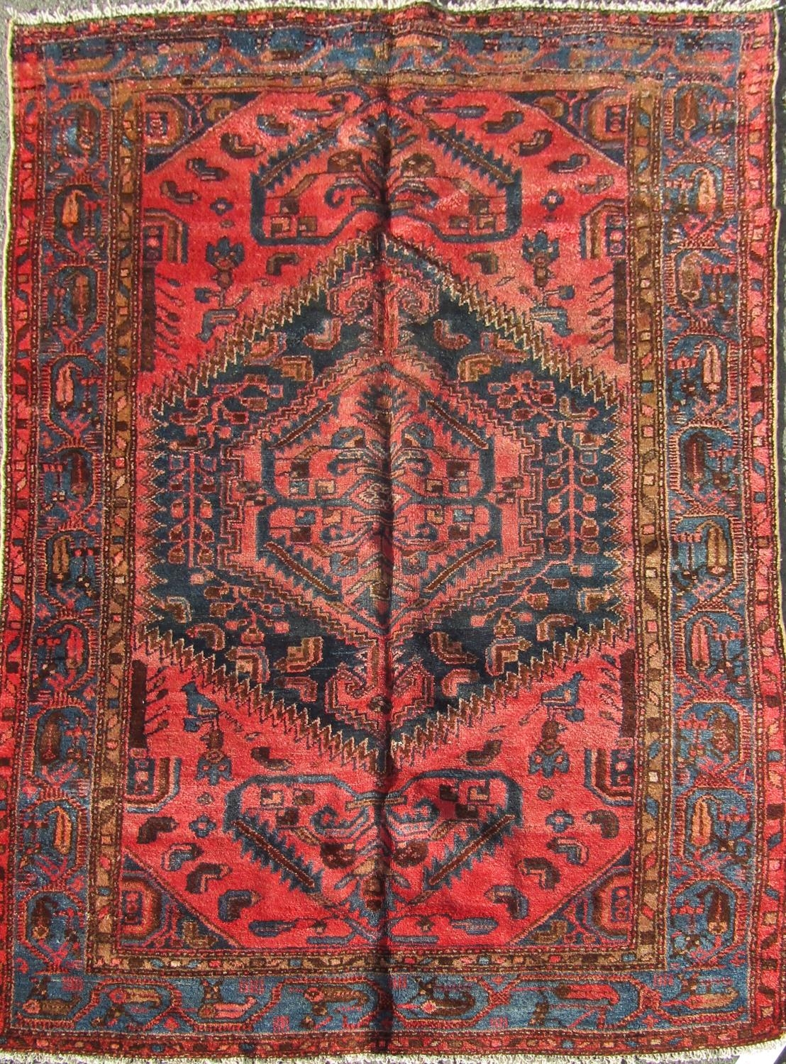 A North West Persian Zanjan Rug, with a central medallion of stylised flowers on a pink ground,192cm