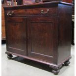 A 19th century mahogany side cupboard enclosed by a pair of rectangular panelled doors with two tray