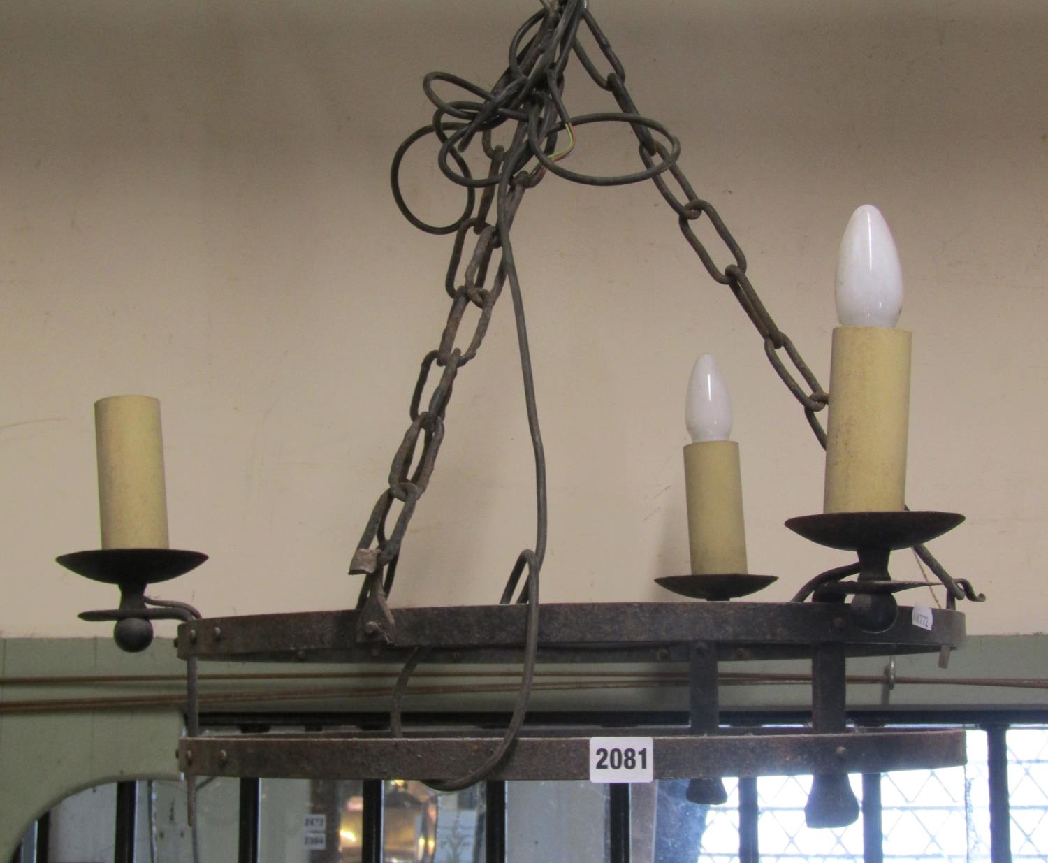 An old English style iron circular strap work hanging ceiling light, chain hung with three candle