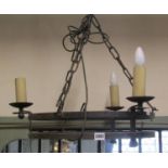An old English style iron circular strap work hanging ceiling light, chain hung with three candle