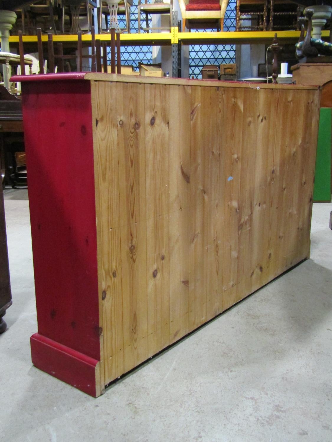 A narrow floorstanding dresser fitted with an arrangement of 22 drawers with stained finish raised - Bild 2 aus 3