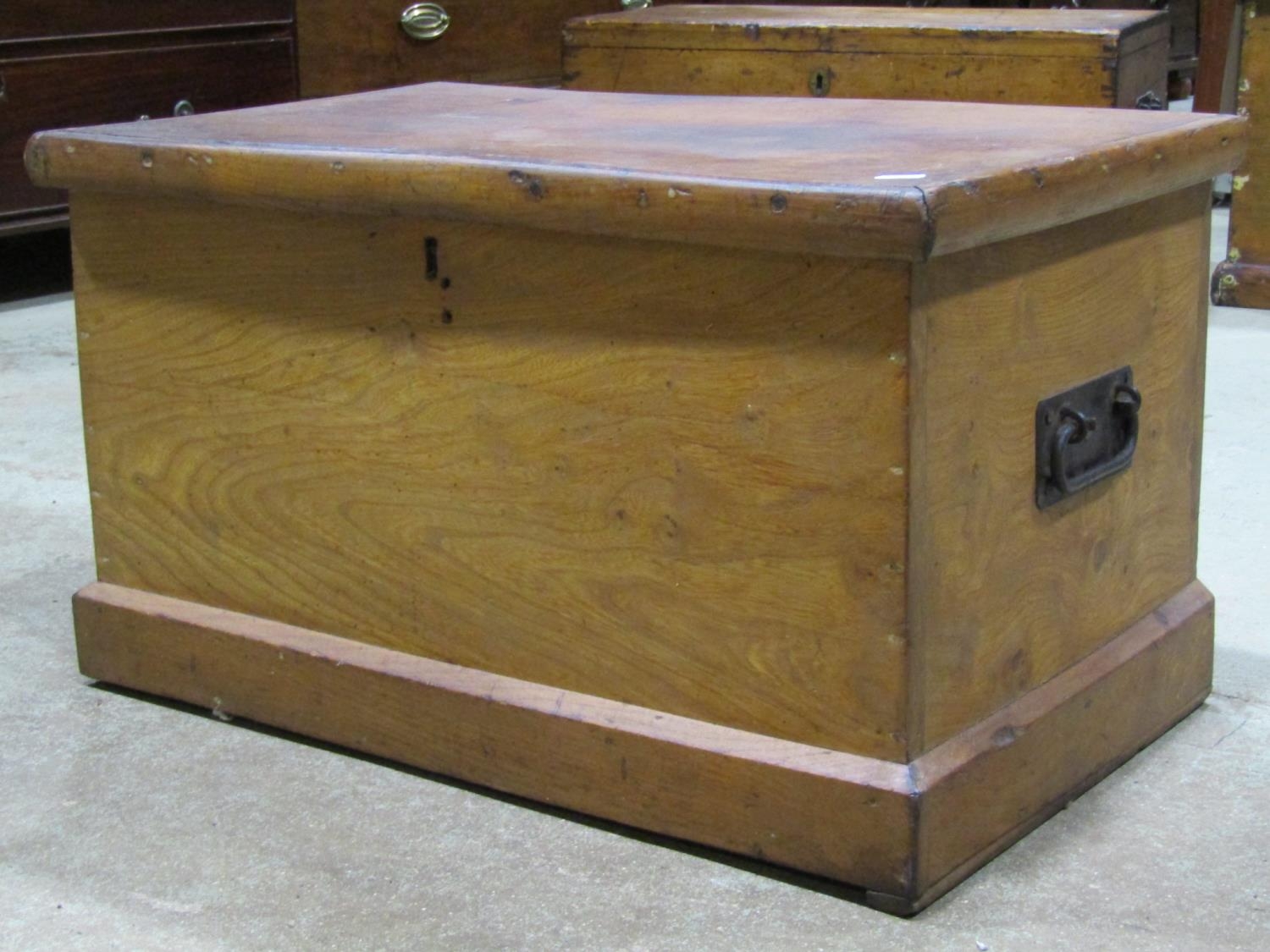 A small 19th century elm box with hinged lid and drop side carrying handles, 67 cm wide x 41 cm deep