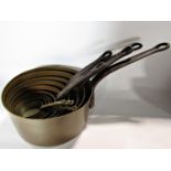 A set of eleven graduated copper saucepans with steel handles, pewter mugs, ships decanter,