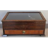 Small table top display cabinet with plate glass top over a single frieze drawer