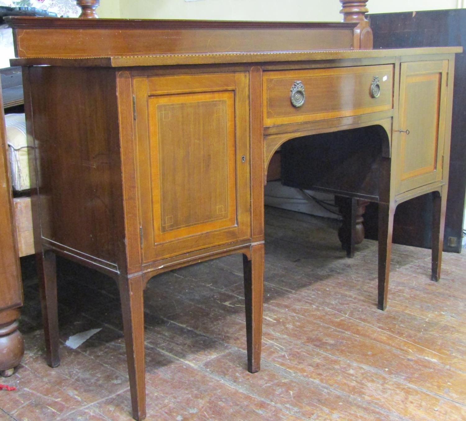 An inlaid Edwardian mahogany sideboard in the Georgian style, with serpentine outline, chequered