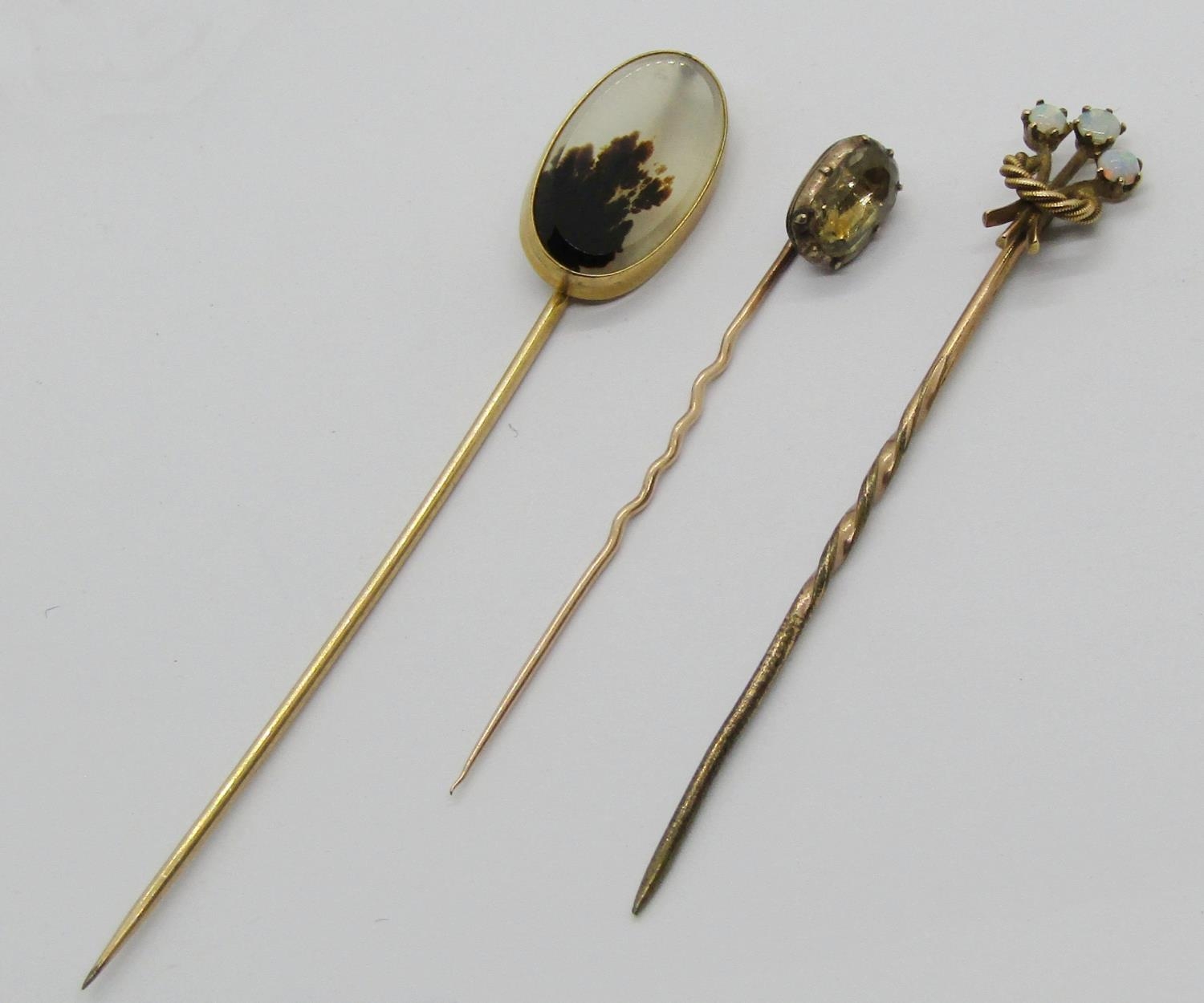 Three antique yellow metal stick pins to include an example with 15ct head set with three opals, 3. - Image 2 of 4