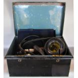 A tin trunk containing a miscellaneous collection of items to include a leather strap with brass