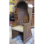 An old hall porters chair principally in pine, the canopied top with pegged finish