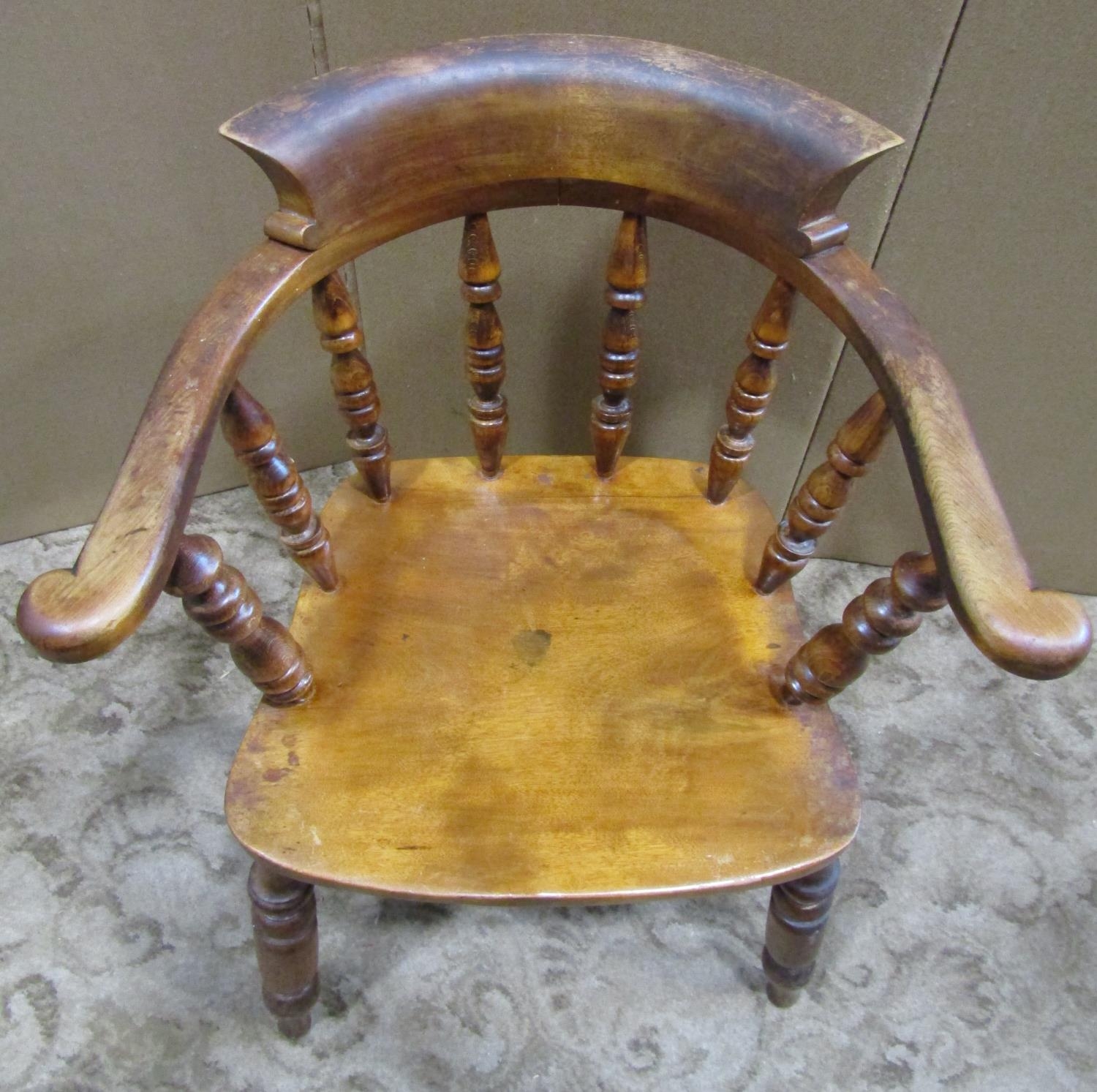 An antique Windsor smokers bow elbow chair in birch and stained beechwood raised on turned - Image 3 of 3