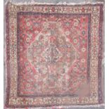 An antique worn Afshar carpet, with a lozenge shaped medallion to the centre and repeating geometric