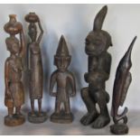 Five small tribal carvings of four characters and a Marlin