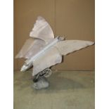 A vintage novel electric table lamp in the form of a moth/butterfly raised on a naturalistic cast