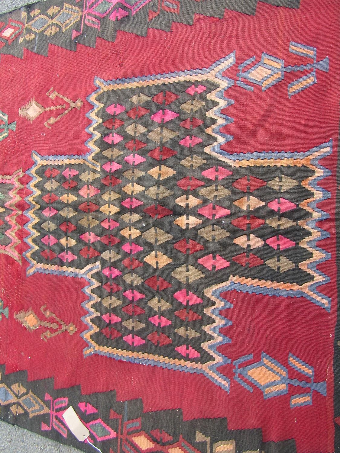 A South West Persian Qashgai Kelim, with a repeating all over pattern on a dark red field, 385cm x - Image 2 of 2