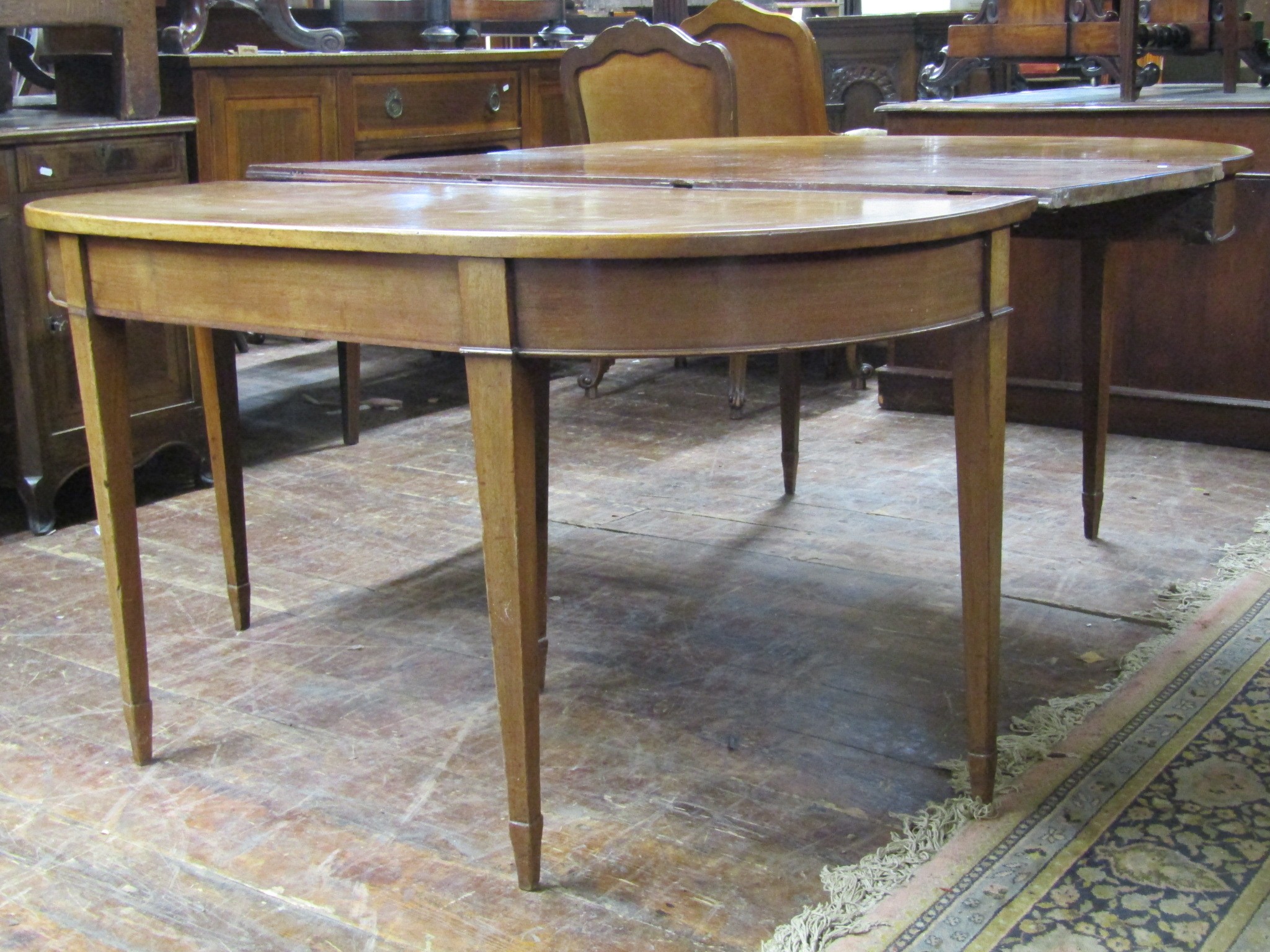 A 19th century mahogany D end sectional dining table with single additional leaf raised on square
