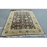 A Persian design carpet with a large floral pattern on a black ground (as found, moth damage), 235