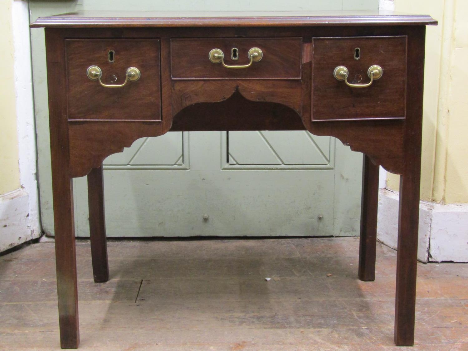 19th century mahogany low boy fitted with three drawers to a central shaped apron and square moulded