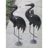 A pair of weathered contemporary compressed tin and cast metal stork garden ornaments 70 cm high