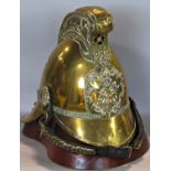 A Victorian Merryweather fireman's helmet in brass with ornate comb detailing a fire breathing