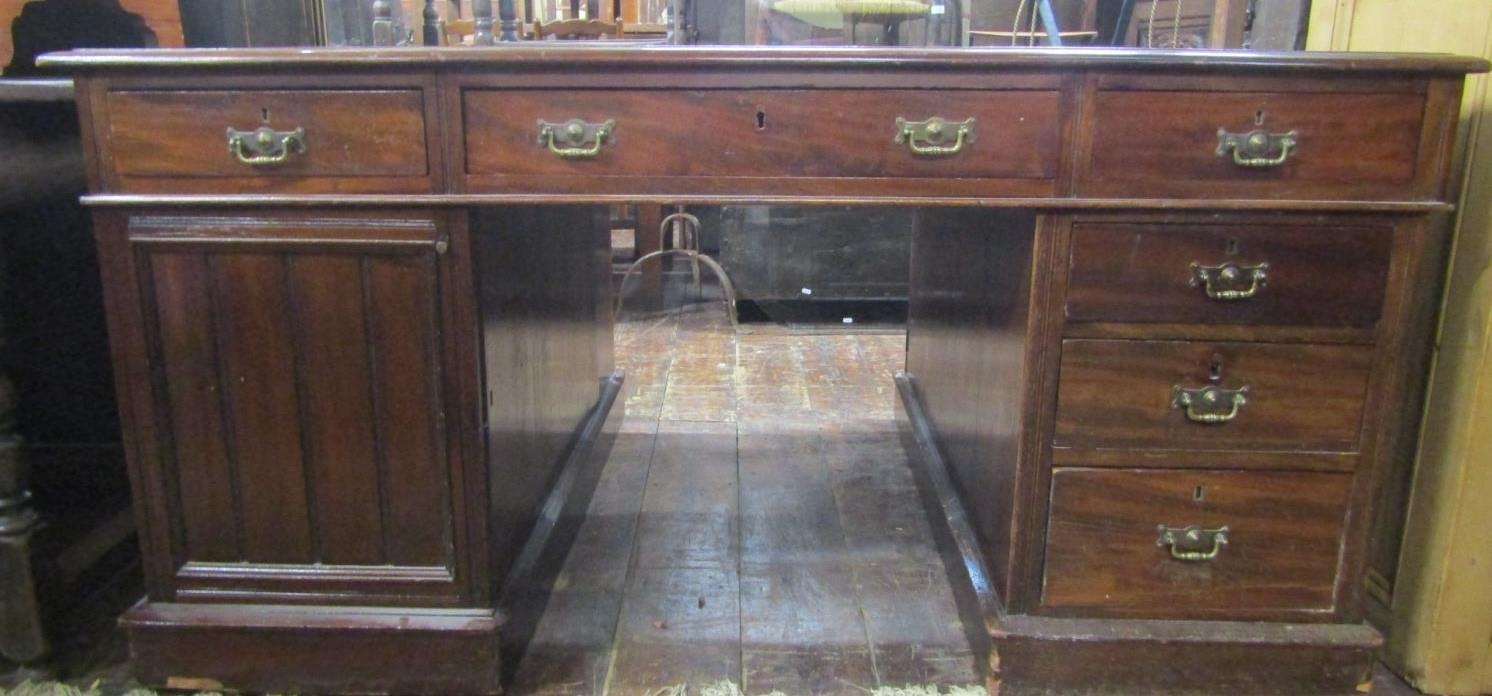 A Victorian mahogany partners desk with inset leather top, each side fitted with six drawers and a