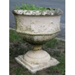 A painted and weathered cast composition stone garden urn of octagonal form with flared rim and