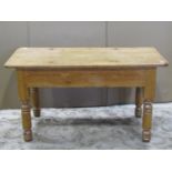 A stripped pine occasional table of rectangular form raised on turned supports, 91 cm long x 44 cm