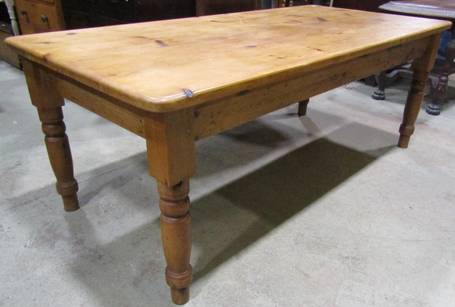 A Victorian style stripped pine farmhouse kitchen table, the rectangular top with rounded corners,