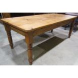 A Victorian style stripped pine farmhouse kitchen table, the rectangular top with rounded corners,