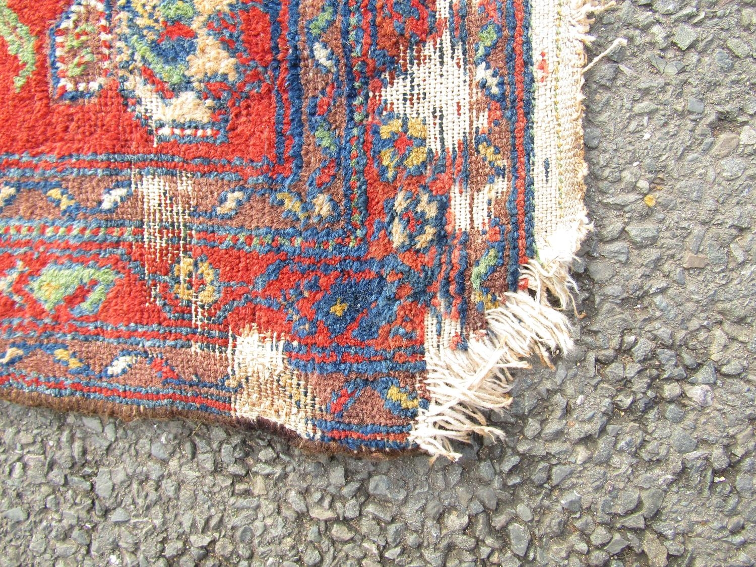 An old Kazak carpet with a central extended medallion and stylised flowers on a dark blue ground, - Image 3 of 4