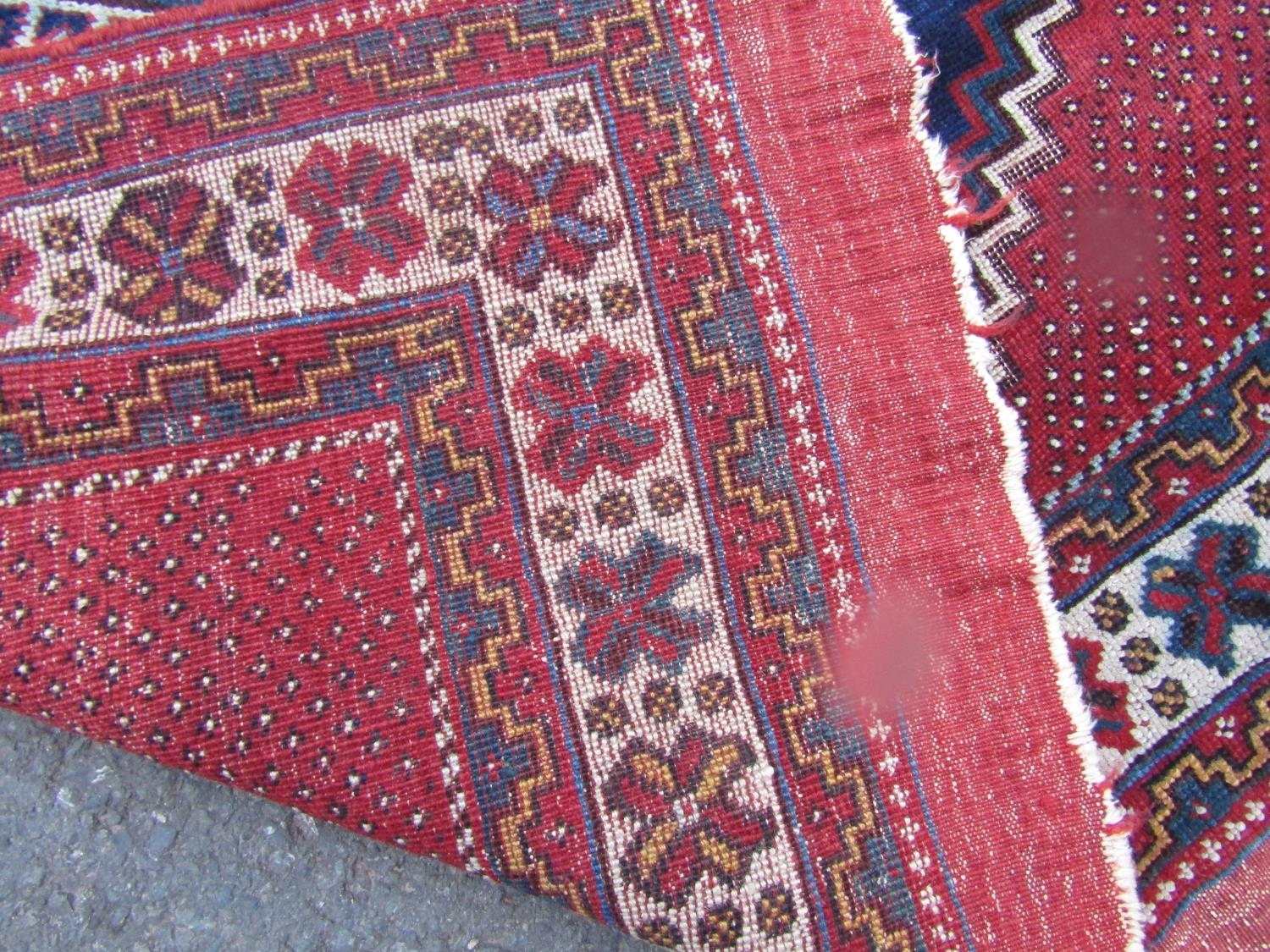 An Antique Persian Tribal carpet with two diamond medallions on a blue ground, 178cm x 120cm approx - Image 3 of 3