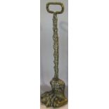 A Regency brass door stop, with weighted lions paw foot and feathered arm