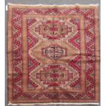 A Turkish Kazak Rug, with three hooked central medallions on a light brown field 189cm x 127cm,