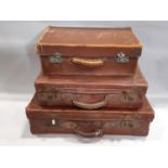 Three small vintage brown fibre and leather reinforced suitcases, the largest example 60 cm x 35