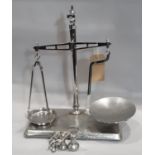 A vintage polished beam balance scale and weights